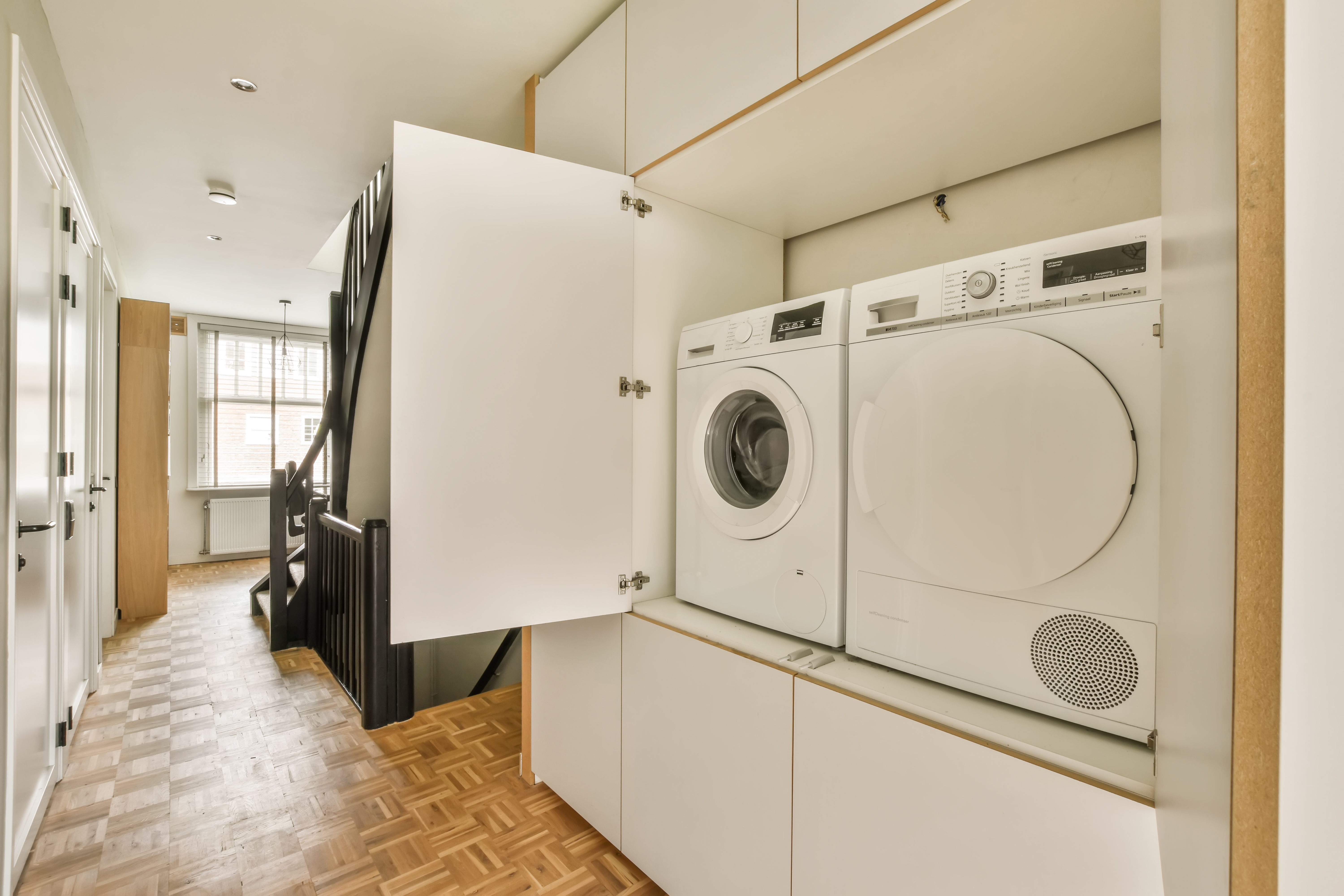Custom Cabinetry Solutions for Hiding Laundry Appliances Beautifully